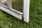 Close-up of rotten wood on exterior screen door, in need of repair