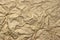 Close-up Of Rough Golden Brown Wrinkled Packaging Paper Texture