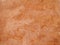 Close up of a rough textured ocher stone wall background