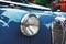 Close up of round retro headlight of blue Austin A35 oldtimer car