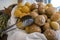 Close up of round shaped different kind of baked small breads made from various ingredients on a white cloth in a basket with a ki