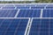 Close up rows array of polycrystalline silicon solar cells or photovoltaics in solar power plant turn up skyward absorb the sunlig