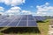 Close up rows array of polycrystalline silicon solar cells or photovoltaics in solar power plant turn up skyward absorb the sunlig