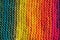 Close up of rows of seamless knitted patterns in vivid rainbow mixed colors