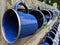 A close up of rows of white and blue camping mugs