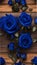 close-up of royal blue roses on a wooden table
