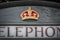 Close up of a royal crown symbol on an english grey phone booth in Bath UK