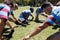 Close up of rugby players touching toes at field