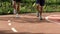 Close up of running feet on red track in the morning in slow motion