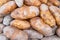 Close up of russet potatoes, freshly harvested, cured and being sold at a farmer`s market. Tuber vegetable