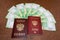 Close up of russian passport with new banknotes nominal 200 rubles on wooden desk