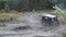 Close-up of Russian suvs participating in a off-road racing and crossing the large puddles. Clip. Russian roads