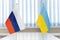 Close up Russian and Ukrainian flags. Diplomats negotiate on war between Russia and Ukraine. International relations. Conflict