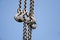 Close up of rusted hanging chain and blue sky