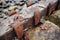 close-up of rusted iron bolts and joints from an old ruined bridge