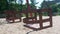 Close-up of rusty metal swing swaying in an empty park.