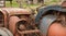 A close-up of a rusty vintage tractor in a village barn