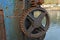 Close up of rusty wheel and cog of manual boat lifting mechanism
