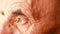 Close-up of sad brown eyes of an elderly caucasian man. Pensioner`s wrinkled face. Nursing home theme. Selective focus, shallow de