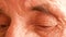 Close up of sad eyes of a Caucasian man 70 years old. Tired look of an old man. Deep wrinkles on the face of a pensioner. Old age