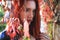 Close up of a sad and melancholic beautiful red head woman among the colorful autumn leaves