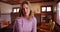 Close up of sad woman sitting inside living room, looking at camera