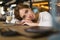 Close up of sad young woman deep in thought outdoors. Portrait of young cute elegant woman sitting outdoor in a cafe in