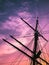 Close-up of a sailboat mast illuminated by a beautiful golden-orange sunset