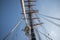 close-up of sailboat's mast, with ropes and sails in motion