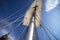 close-up of sailboat's mast, with ropes and sails in motion