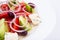 Close up of salad with cheese and fresh vegetables in white plate. Greek salad