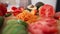 Close-up salad ingredients lying on wooden cutting board on table. Live camera moves forward slowly. Healthful organic