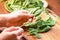 Close-up Salad with spinach. Healthy and fresh food.Bowl overfilled with spinach.Female hands sorting fresh spinach for