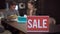 Close-up Sale announcement with blurred man and woman talking choosing furniture upholstery at background. Seller and