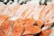 Close up sale of chilled steaks and backs of salmon and trout on ice