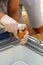 Close up of salesman hands in gloves putting icecream to a cone.