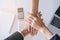 Close-up of salesman shaking hands with lovers who are customers In her office in the house purchase agreement Asian women