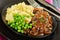 Close-up of salisbury steaks with green peas