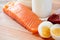 Close up of salmon fillets, eggs and milk on table