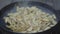 Close-up of salting potatoes on frying pan. Unrecognizable Caucasian man or woman cooking dinner outdoors on bbq grill