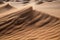 close-up of sand dune, with the grains swirling in the wind