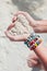 Close-up of sand heart in woman\'s hands