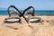 Close-up sandals on the sand at the beach. Sports summer shoes. Hiking, outdoor activities.