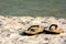 Close Up of Sandals on White Sand on Blur Ocean Water. Destin Beach, Florida