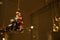 Close-up of Santa Clause bauble on motorcycle. Retro and vintage decoration in illuminated showcase in dark evening