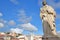 Close-up on Sao Vicente Statue at Santa Luzia viewpoint miradouro with Sao Vicente de Fora Church in the background, Lisbon, Por