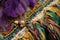 close-up of sash on mardi gras card, with intricate beadwork and fringe
