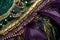 close-up of sash on mardi gras card, with intricate beadwork and fringe