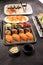 Close up of sashimi sushi set with chopsticks and soy - sushi roll with salmon and sushi roll with smoked eel