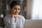 Close up satisfied Indian woman looking at laptop screen